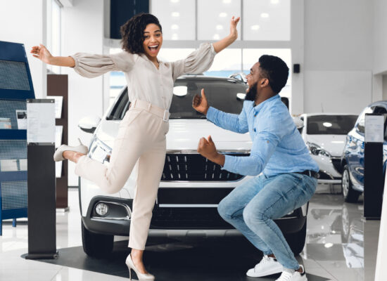 joyful-african-couple-jumping-buying-automobile-in-1920-1100